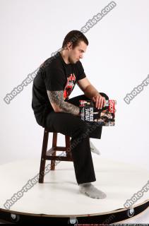 Alex Sitting With Pistol Pose